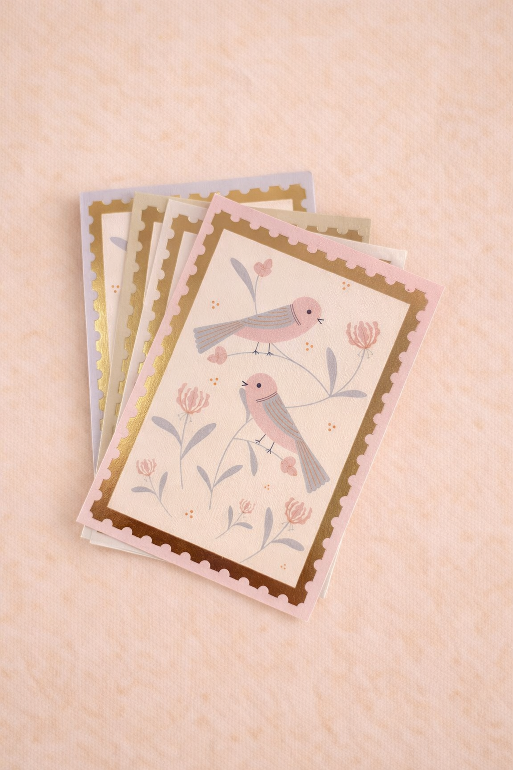 Set of greeting cards with bird illustrations on a beige background
