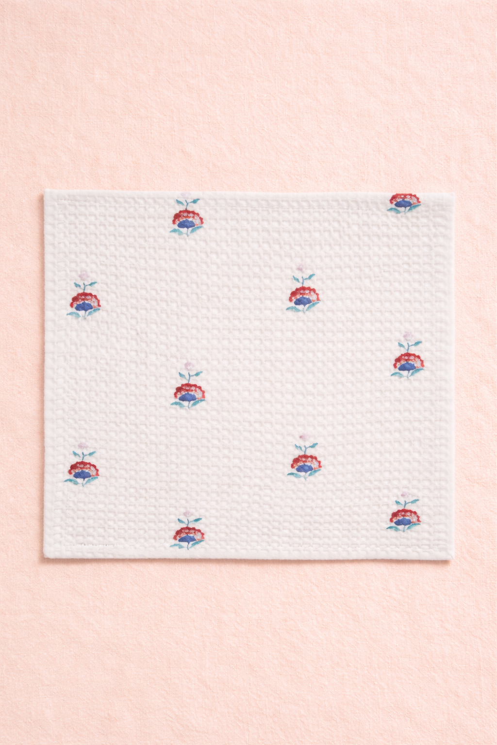 Handcrafted ivory cotton waffle towel featuring repeating hand block-printed floral motifs