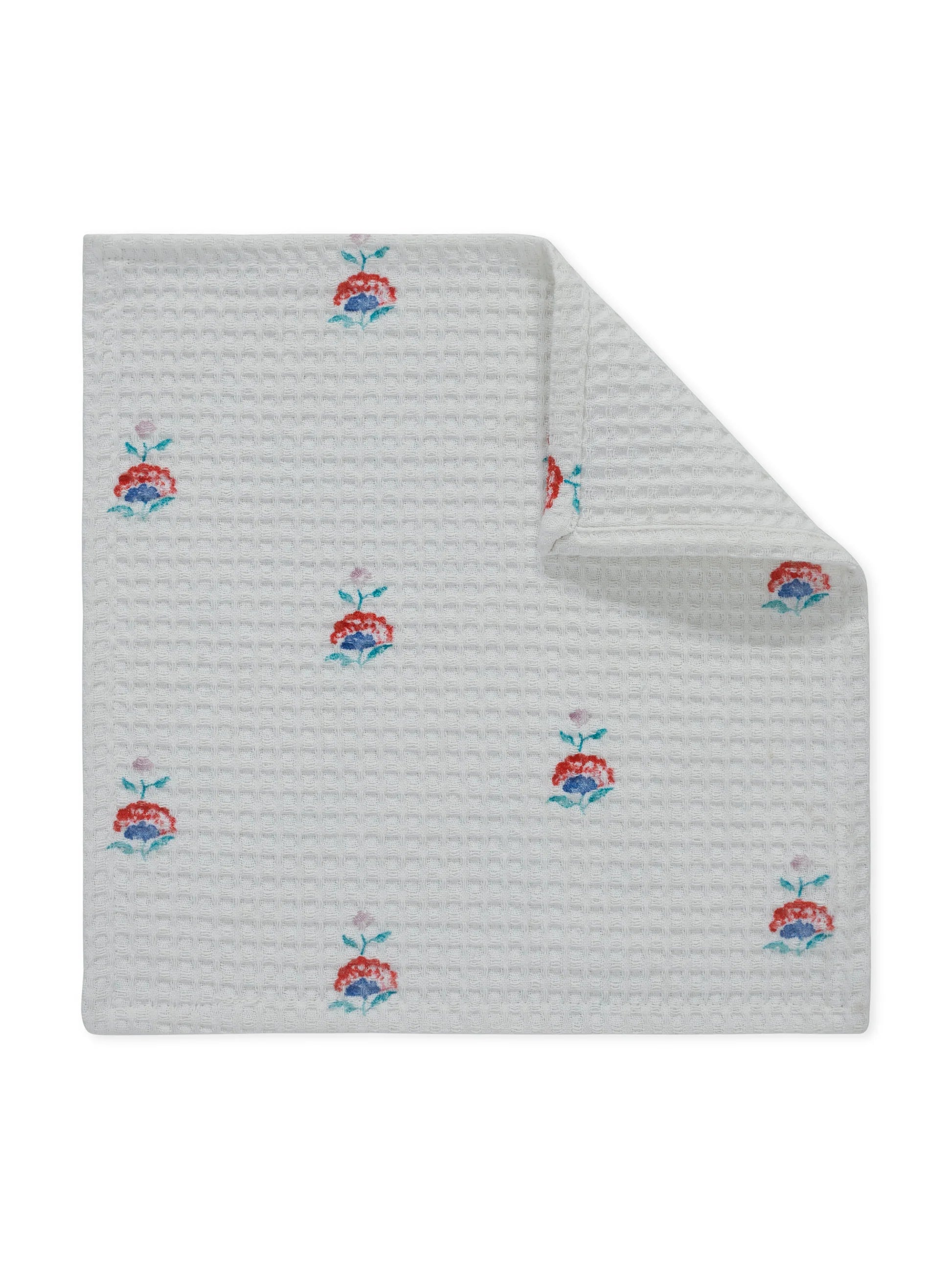 White textured blanket with floral patterns on a white background