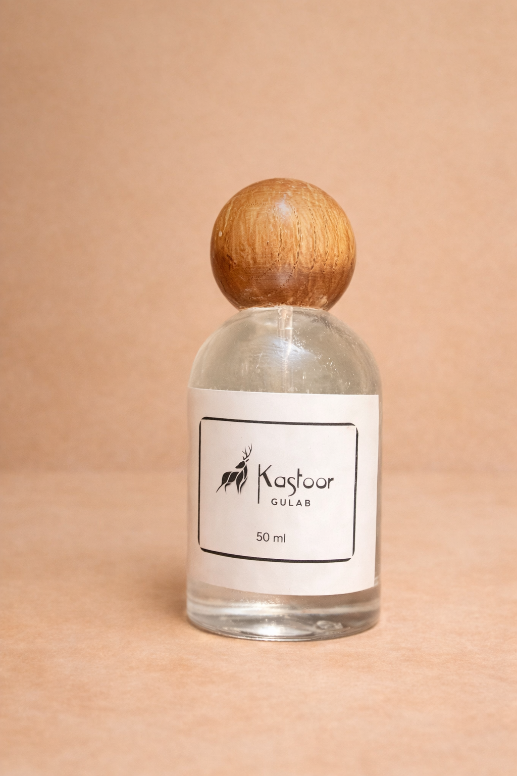 Clear glass bottle of Kastoor Gulab rose water
