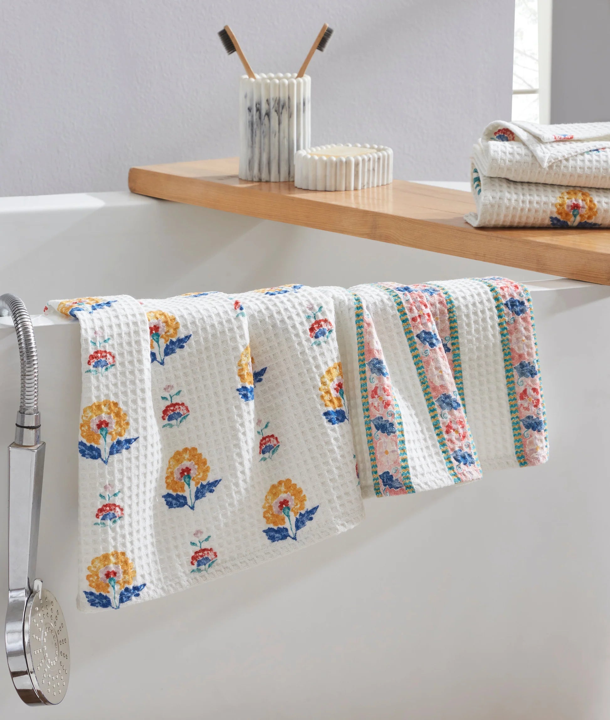 Floral-patterned towel hanging on a rack with a shelf in the background
