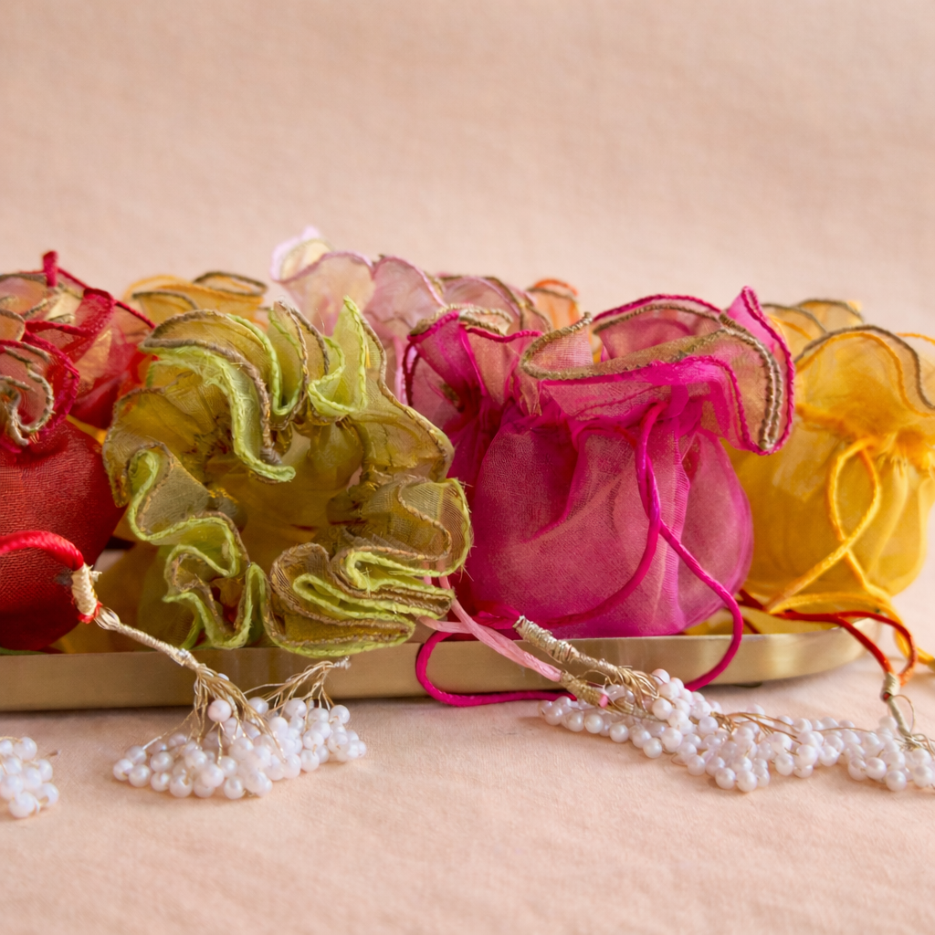 Colorful decorative bags with ribbons on a beige background