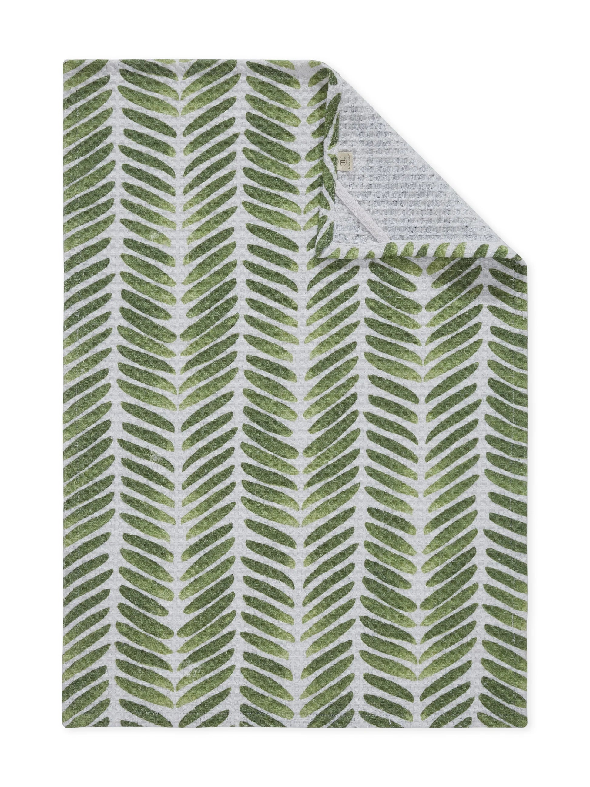 Green leaf patterned blanket on a white background